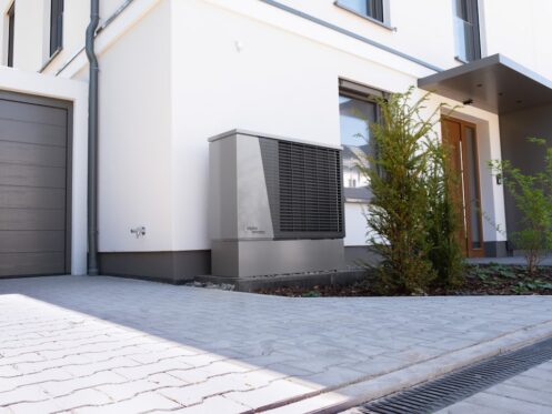 heat pump system installed outside a modern home in a sunny desert climate